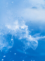 Pattern of ice texture close up. Macro shot. Soft focus. Blue gradient background.