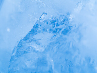 Macro view to ice texture. Close up shot. Soft focus. Blue background.