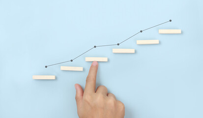 Block stacking as step stair in hand. Business concept