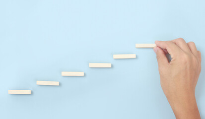 Block stacking as step stair in hand. Business concept