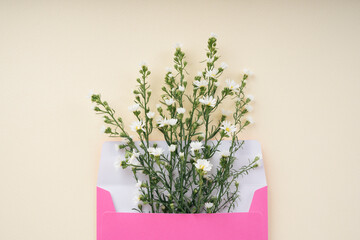 White gypsophila flower bouquet in pink letter enclosed.