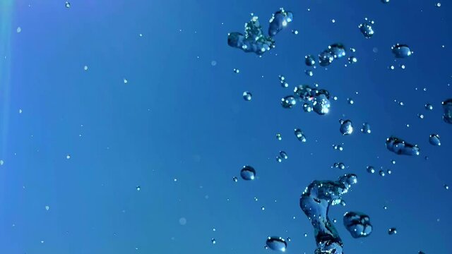 splash of water in slow motion, blue sky background.