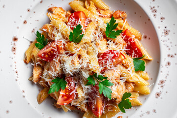 Penne pasta in tomato Bolognese sauce, chicken meat and parmesan cheese. quick delicious pasta meal Italian food. Food recipe background. Close up