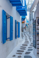 Tourist shops at a narrow street in the old town of Mykonos, Greece