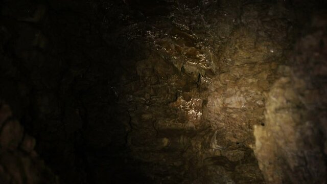 Natural cave in the rock. A cave that is underground with beautiful illuminated stones, stalagmites. 