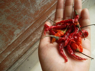 hand holding red pepper