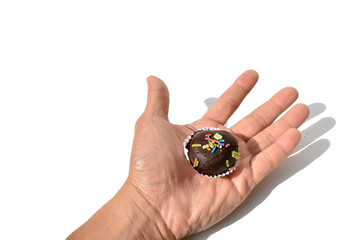 Chocolate ball and hand on a white background