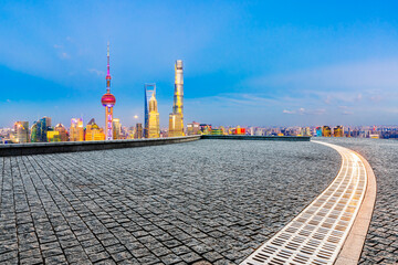 Fototapeta premium Empty square floor and Shanghai skyline with buildings at night,China.High angle view.