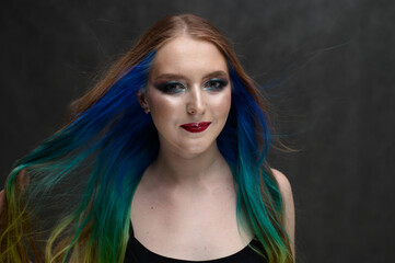 Fototapeta premium Model with perfect healthy dyed hair. Beauty fashion model girl with colorful dyed hair. Girl with perfect makeup and hairstyle.