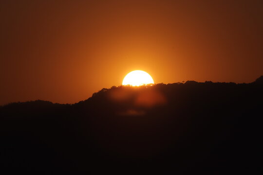 A beautiful picture of sun setting behind the mountains