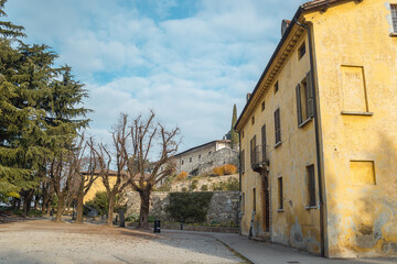 Park in the castle of the city of Brescia on a sunny clear day against a bright blue sky. Part of Brescia castle. Castello di Brescia, Lombardy, Italy.