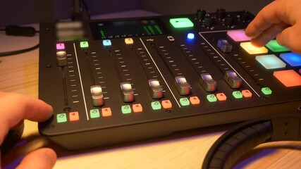 Fingers are pushing some buttons on record device - Record a podcast show