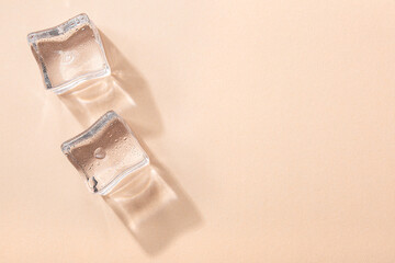 Ice cubes on vibrant light coral colors. Concept art. Minimal surrealism. Flat lay with copy space. Soft focus.