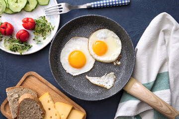 Creative breakfast for children with eggs on dark background