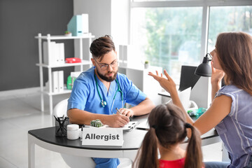 Little girl and her mother visiting allergist in clinic
