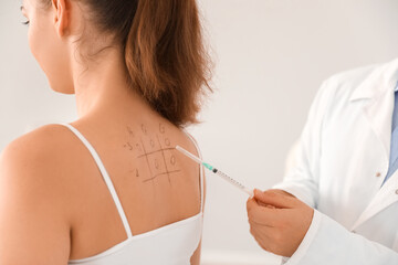 Young woman undergoing allergen skin test in clinic
