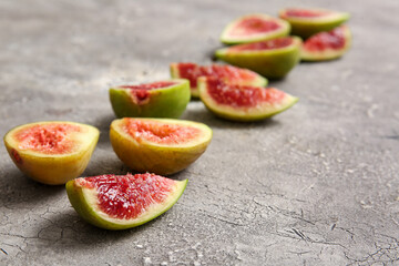 Cut fresh figs on grey background, closeup