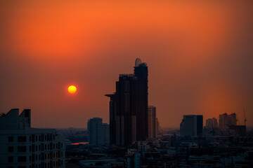 Fototapeta premium The high angle background of the city view with the secret light of the evening, blurring of night lights, showing the distribution of condominiums, dense homes in the capital community