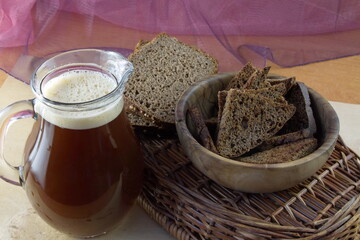 Bread kvass in a jug with a foam cap made of rye bread - a traditional Russian home-made drink
