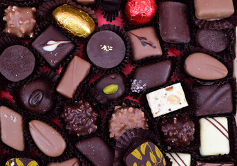 Assorted chocolates laid out on red corrugated paper