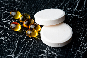 close-up of pills of vitamins, on black background