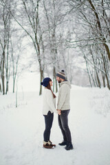 Fototapeta na wymiar Man,woman couple at snow forest