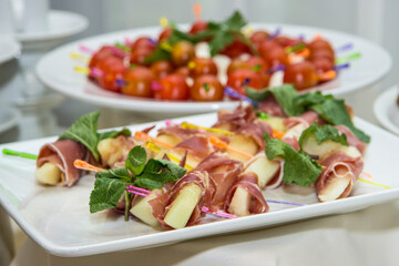 Food snacks and appetizers with cheese, meat  on table. Catering banquet table. Catering party. Corporate event or wedding celebration.