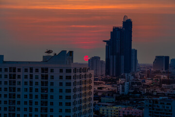 The high angle background of the city view with the secret light of the evening, blurring of night lights, showing the distribution of condominiums, dense homes in the capital community