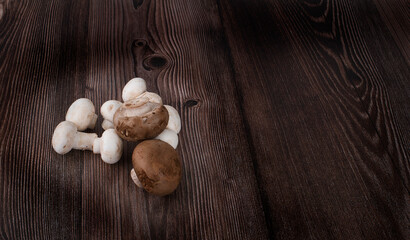 Fresh champignon mushrooms isolated on wooden table.