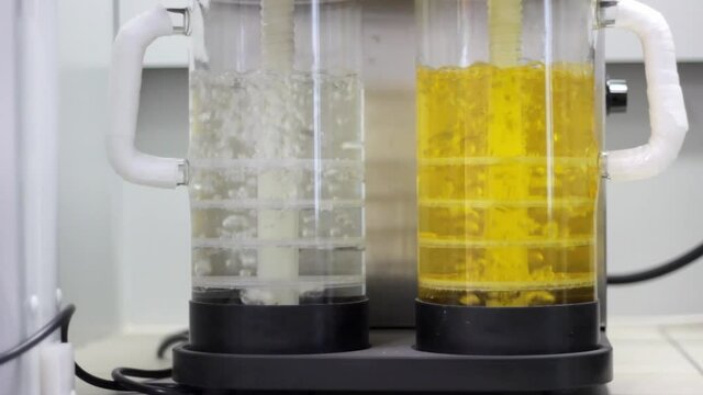 The alkali poured into the container traps sulfuric acid vapors during sample firing. Air is forced through the liquid. scruber work in a chemical laboratory