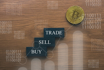 Bitcoin cryptocurrency concept with a graph buy, sell and trade.