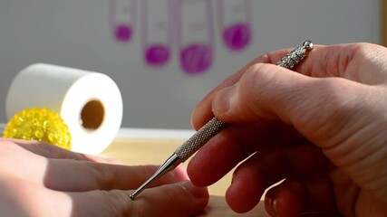 Close up view hands and Su jok steel probe used by professional acupuncture therapist. Searching skin pain points with special wand tool. Alternative korean medicine Su Jok in health care and recovery