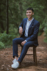 Obraz premium Asian groom portrait in forest 