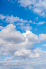 Naklejka na ściany i meble White clouds in a spring blue sky