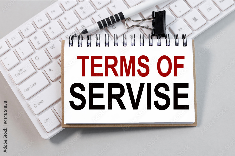 Fototapete term of service. text on white notepad paper on white keyboard on gray background