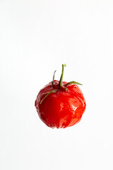 Creative image of a tomato isolated on a white background. Tomato in tomato paste.