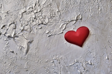 Red heart on coating putty with pearlescent paint  with uneven coating with silver gold paint....