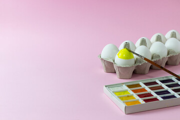 Easter chicken eggs painted on a pink background