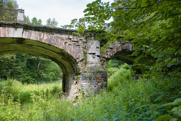 Big white stone bridge in the park of the Serednikovo estate on a summer day