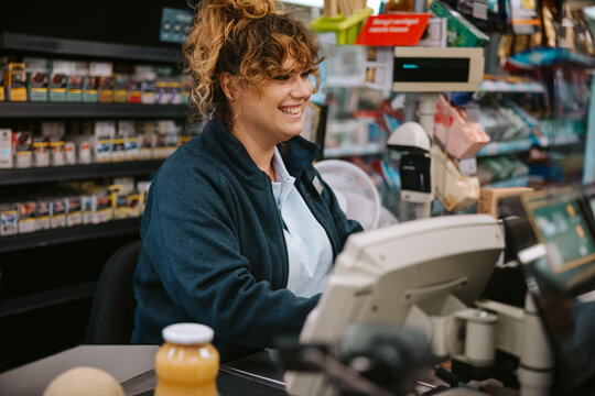 Female Cashier Working On Cash Register In A Modern Supermarket