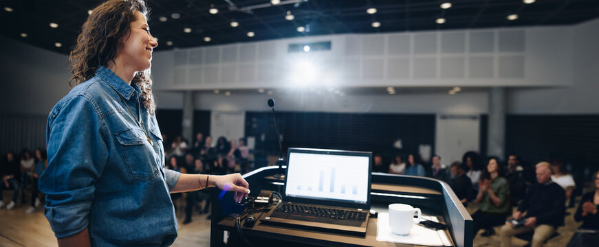 Businesswoman giving a presentation at a seminar in a corporate event