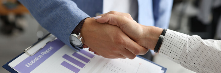 Closeup of man and woman shake hands. Conclusion of contracts in the office concept.