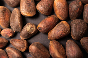 Background of pine nuts from Siberia close-up, you can see all the details of the shell.