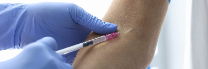 Nurse in rubber gloves makes intravenous injection closeup. Laboratory diagnosis of diseases...