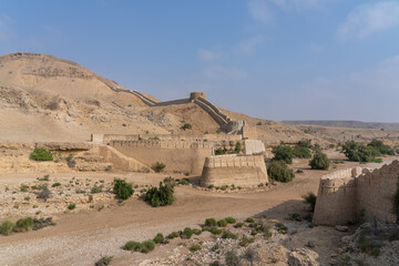 Desert landscape view of Sann gate and ramparts at ancient Ranikot fort known as the great wall of Sindh in Jamshoro, Sindh, Pakistan