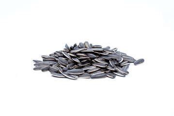 A pile of black sunflower seeds on a white background
