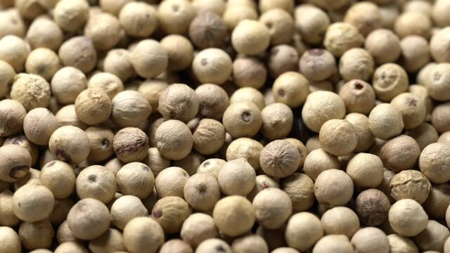 Close-up video of a slowly rotating white pepper