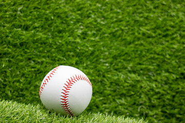 Baseball is on green grass background
