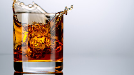 Ice Cube falling into Glass of Whisky, Freeze Motion.