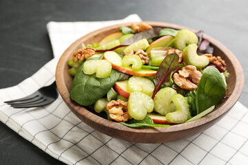 Delicious fresh celery salad on black table, closeup